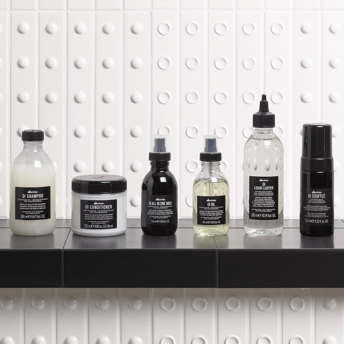 Davines OI Shampoo with the OI range on a bathroom shelf